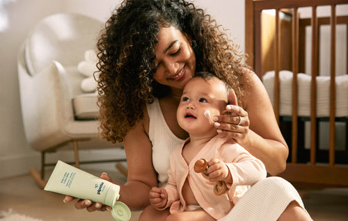 Mom applying Pipette Baby Lotion to Baby.