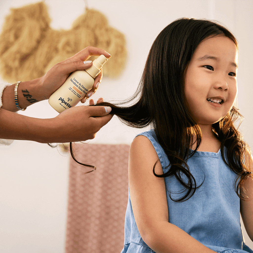 Mom Applying Leave-In Detangler to Kiddo's Hair